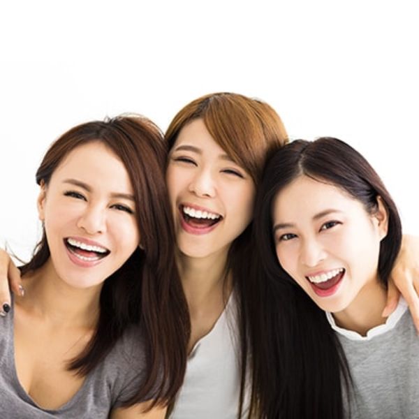 Three smiling young ladies in retainers